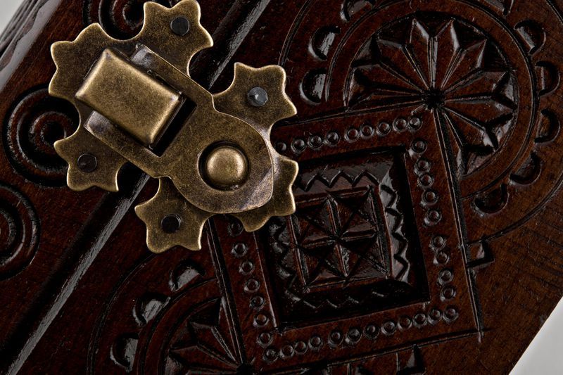 Wooden jewelry box with hand carved pattern.
