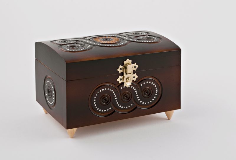 Wooden jewelry box inlaid with beads.