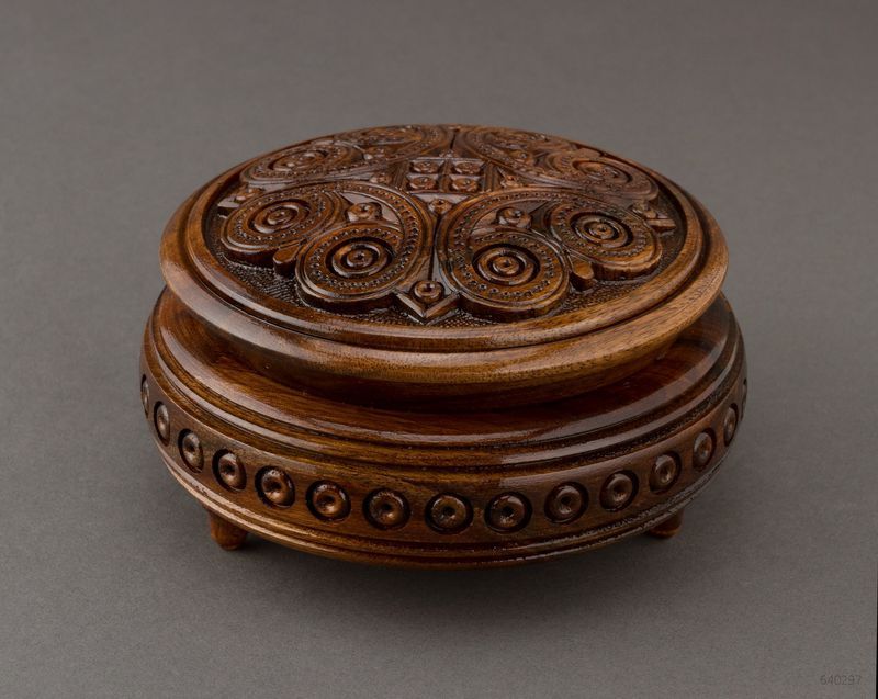 Handmade round wooden jewelry brown box with carving.