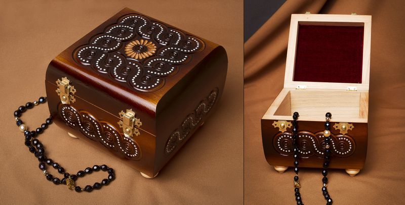 Wooden jewelry box inlaid with beads.