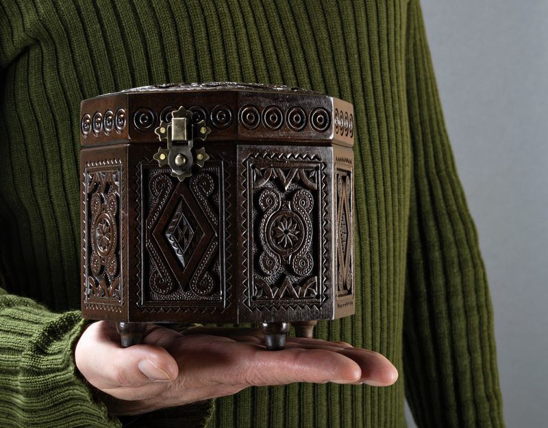 Original carved wooden octahedral box.