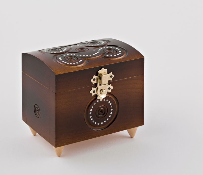 Wooden carved jewelry box inlaid with beads.