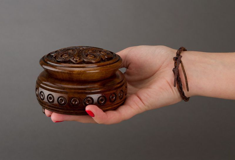 Hand carved round wooden brown jewelry box. 