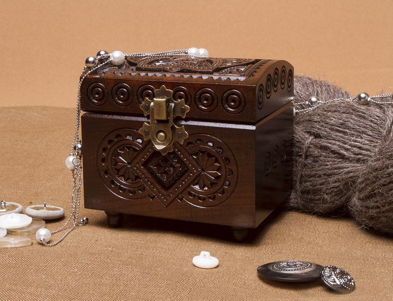 Wooden jewelry box with hand carved pattern.