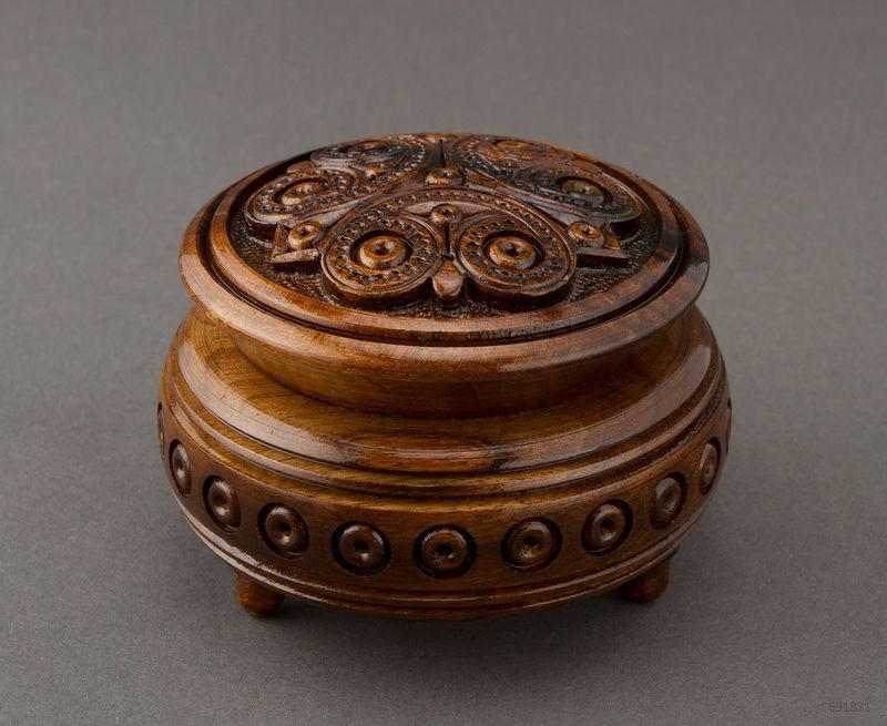 Hand carved round wooden brown jewelry box. 