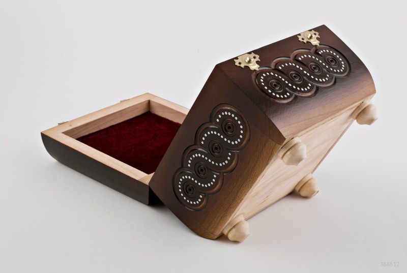 Wooden jewelry box inlaid with beads.