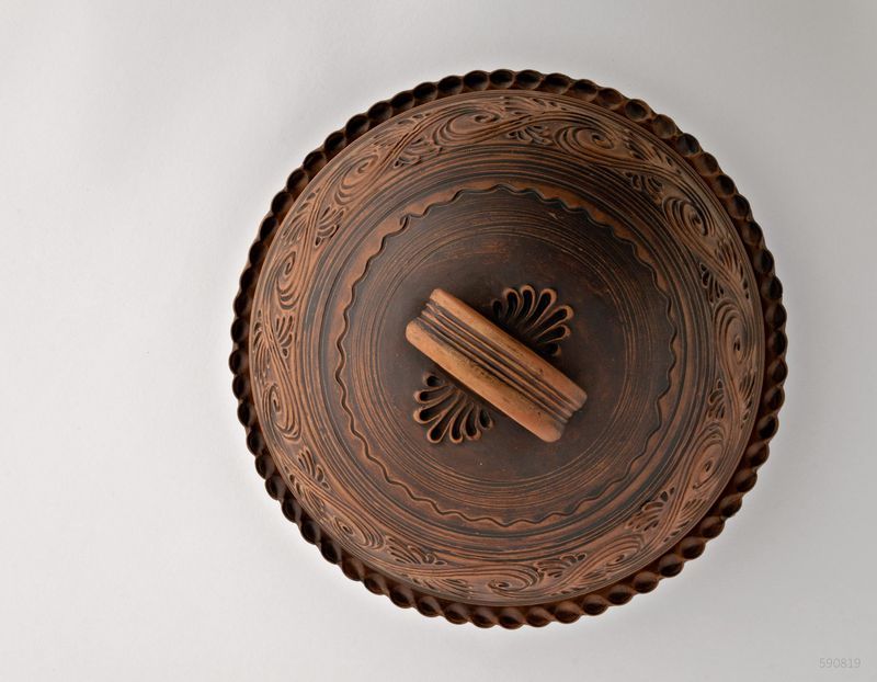 Brown ceramic bowl, plate with lid made of red clay.