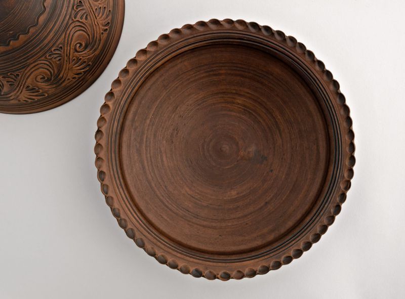 Brown ceramic bowl, plate with lid made of red clay.