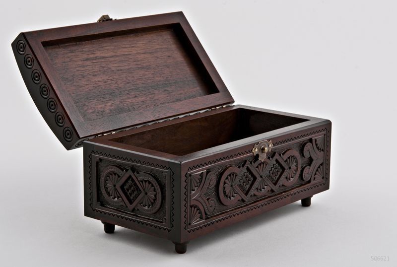 Wooden rectangular jewelry box with hand carved pattern.