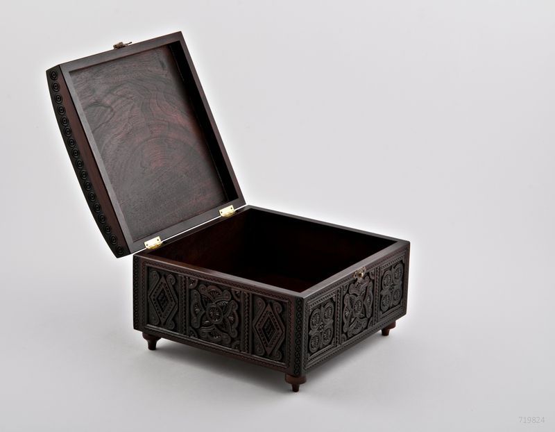 Wooden rectangular jewelry box with hand carved pattern.