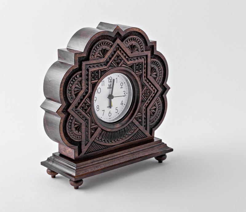 Wooden alarm clock with hand carved pattern.