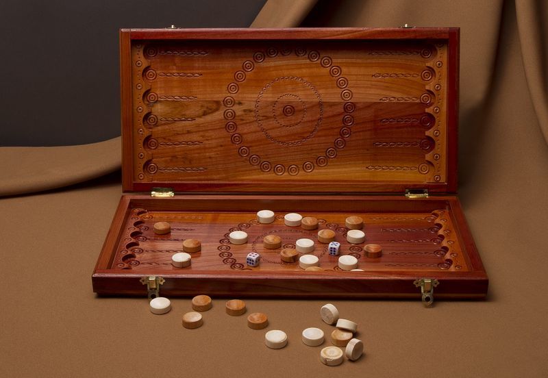 Wooden backgammon with hand carved pattern. 