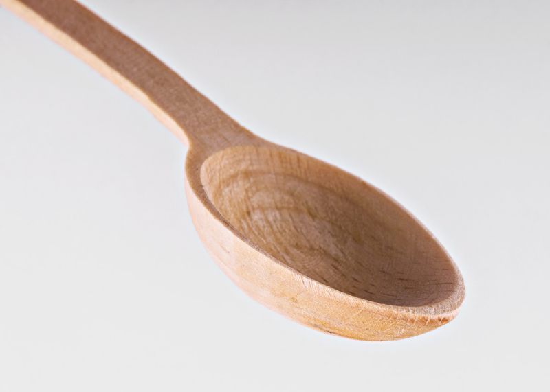 Wooden kitchen spoon made by hands.