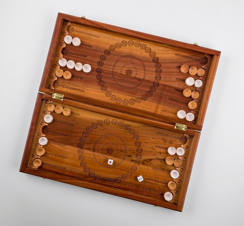 Wooden backgammon with hand carved pattern. 