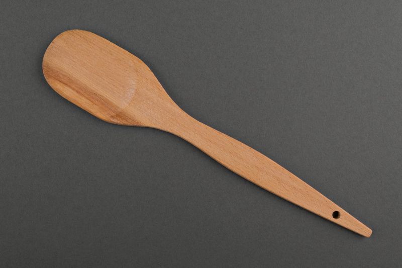 Wooden spatula made by hands.