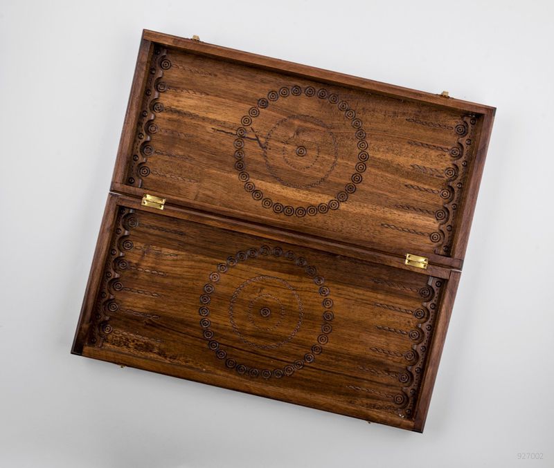 Wooden backgammon with hand carved pattern. 