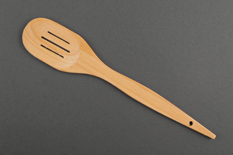 Wooden spatula made by hands.