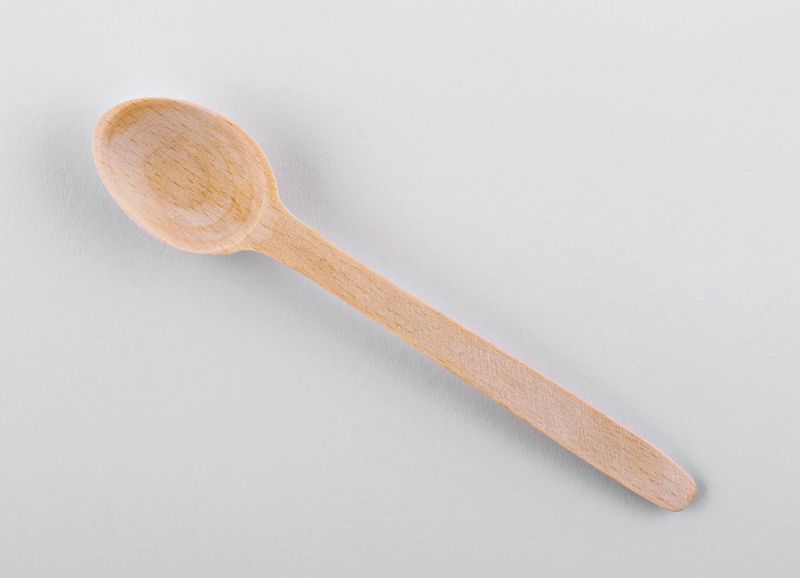 Wooden kitchen spoon made by hands.