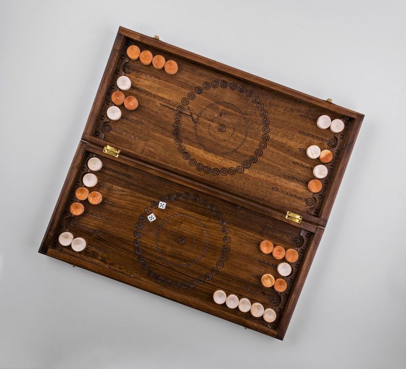 Wooden backgammon with hand carved pattern. 