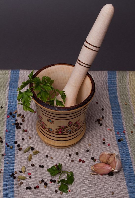 Wooden mortar and pestle for grinding spices by hand.