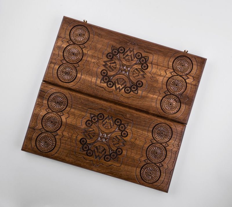 Wooden backgammon with hand carved pattern.