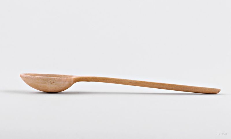 Wooden kitchen spoon made by hands.