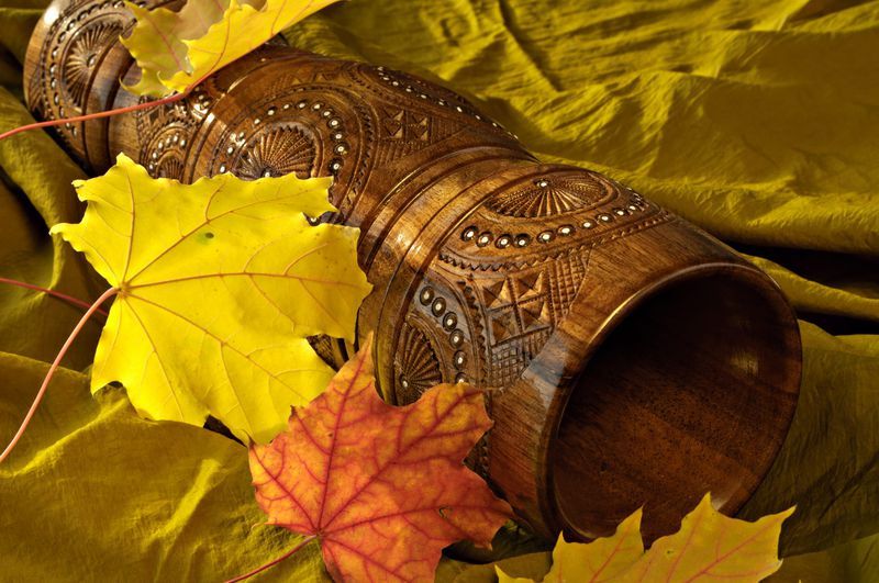 Decorative wooden table vase inlaid with beads. 