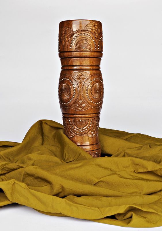 Decorative wooden table vase inlaid with beads.