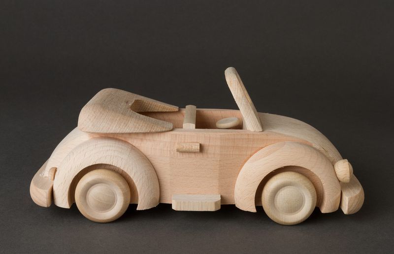 Children's wooden toy car in retro style for play and creativity.