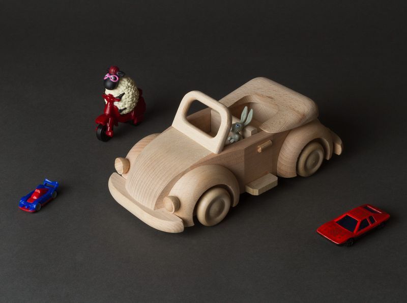 Children&apos;s wooden toy car in retro style for play and creativity.