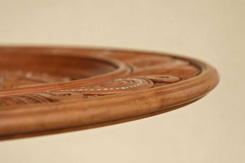 Interior plate with art carving and bead inlay
