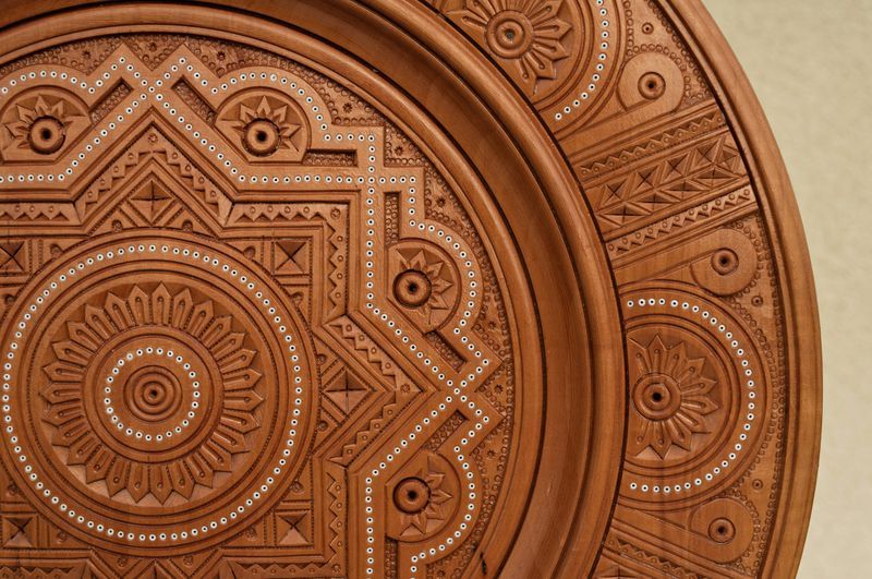 Interior plate with art carving and bead inlay