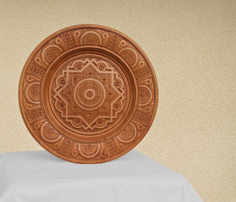 Interior plate with art carving and bead inlay