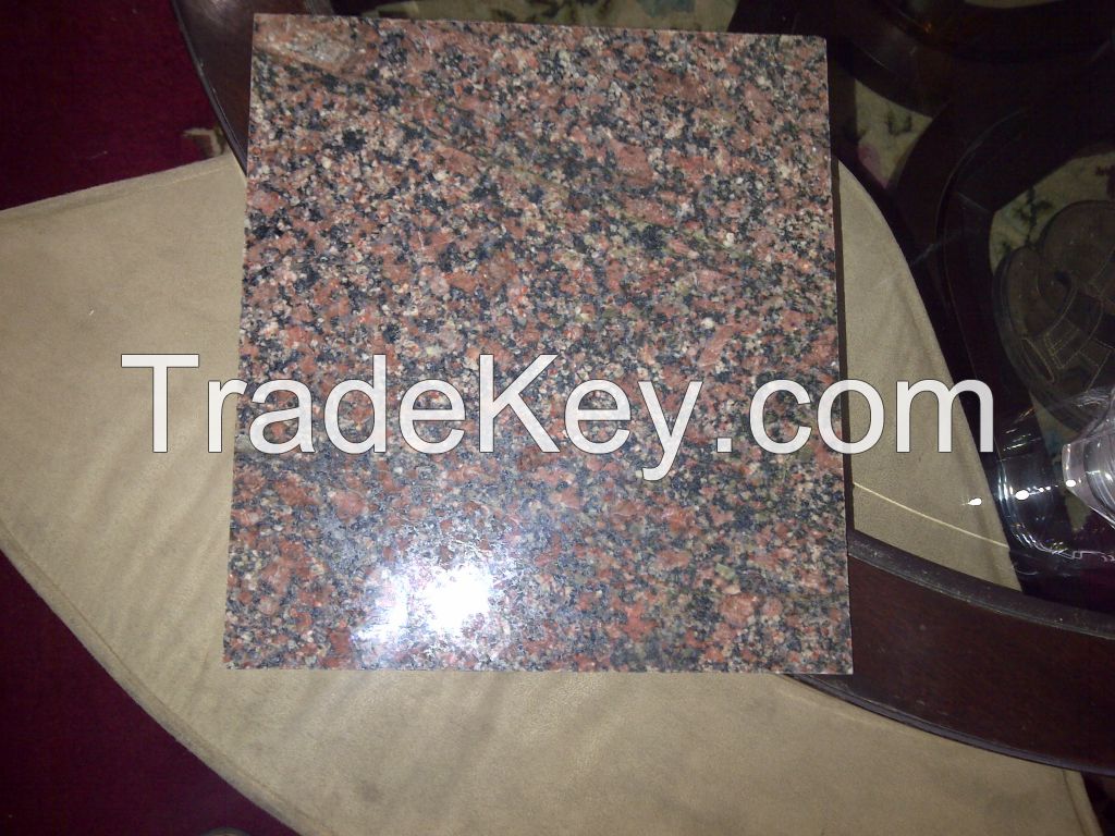 Flesh Red coloured rough granite blocks and processed granite tiles and slabs of required sizes.