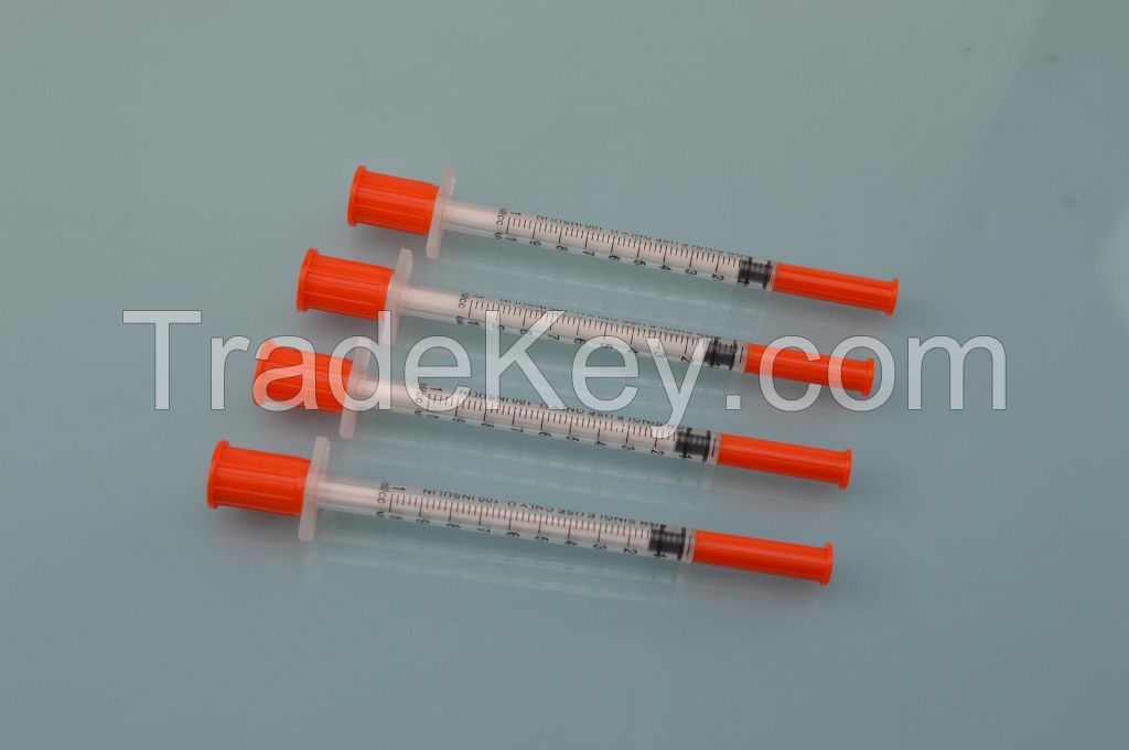 disposable insulin syringe with fixed needle and orange caps