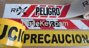 barricade  tape legend with Arabic precaution or peligro