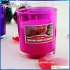 scented candles in colored glass jar 