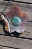 Semi-black Mintabie solid opal on a Papua shell