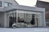 Sliding frameless glazing system