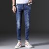 Man's fashionable dark blue ripped slim fit denim jeans