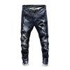 Mans fashionable ripped denim pants with patch