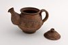 Ceramic tea pot made of red clay.