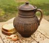 Ceramic jar with lid made of red clay. 