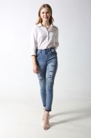 Woman's slim denim jeans with distress and patches with rhinestones