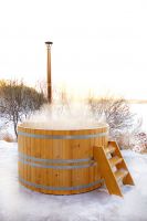 Cedar plungÑƒ tub with submersible wood stove