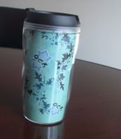 plastic mug with advertising paper in middle