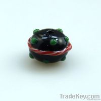 lampwork glass black bead with red swirl and green dots
