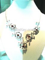 Silver necklace set with five garnets